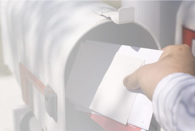 man taking mail out of mailbox